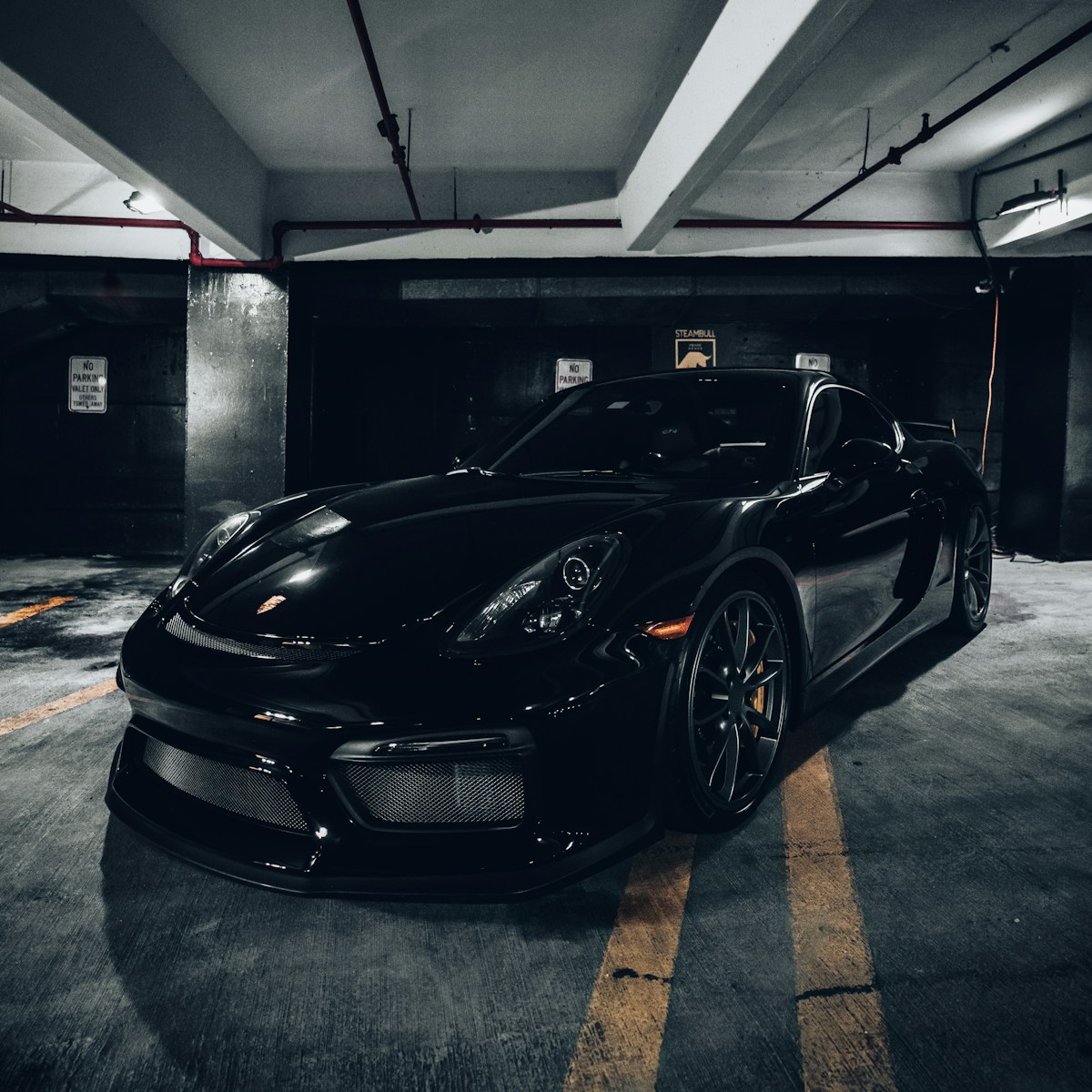 Black sports car in a garage