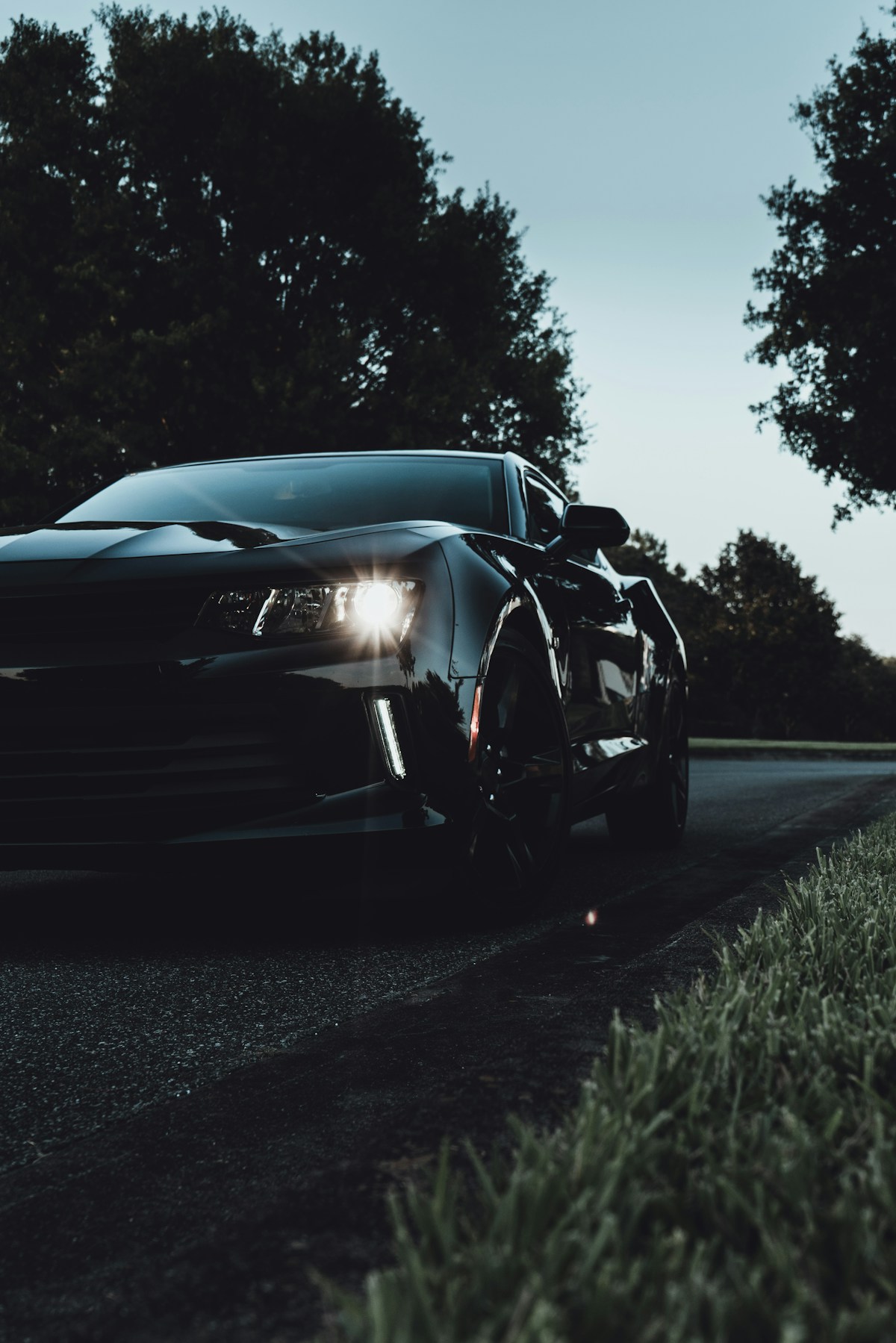 Dark car with tinted windows at dusk