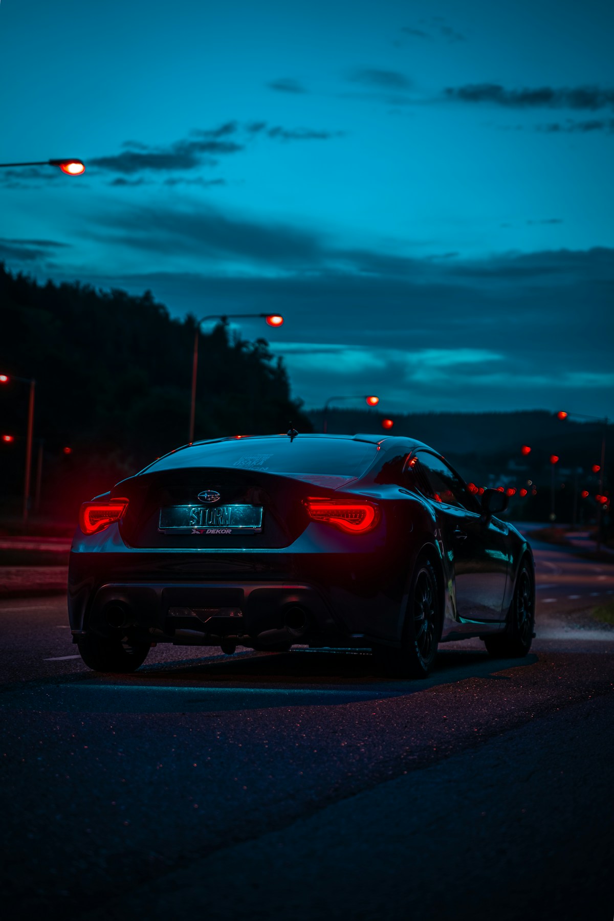 Car tail lights on the road at night